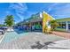 Street view of a commercial property with multiple storefronts and ample parking at 26950 Pavin Dr, Englewood, FL 34223