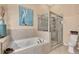 Bathroom features a soaking tub, walk-in shower, and neutral tile at 3363 Grand Vista Ct # 203, Port Charlotte, FL 33953