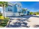 Light blue, two-story building with attached garages and palm trees at 3923 Cape Haze Dr # 306, Rotonda West, FL 33947