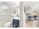 Clean bathroom with a walk-in shower and view to kitchen at 1115 Larchmont Dr, Englewood, FL 34223