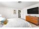 Bright bedroom with a comfortable bed and a large TV at 1115 Larchmont Dr, Englewood, FL 34223