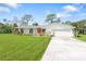 Single story home with attached garage and green lawn at 1115 Larchmont Dr, Englewood, FL 34223