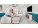 Bright living room with sectional sofa, large TV, and coastal decor at 1115 Larchmont Dr, Englewood, FL 34223