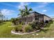 Landscaped backyard with a pool and screened enclosure at 1337 Sorrell Way, North Port, FL 34289