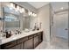 Double vanity bathroom with modern fixtures and marble flooring at 1337 Sorrell Way, North Port, FL 34289