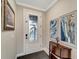 Bright entryway with hardwood floors, a console table and framed art at 1337 Sorrell Way, North Port, FL 34289