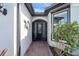 Front entry with brick walkway, iron gate, and decorative wall art at 1337 Sorrell Way, North Port, FL 34289