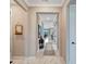 Elegant hallway with marble floors, crown molding, and access to other rooms at 1337 Sorrell Way, North Port, FL 34289