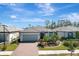 Single-Gathering home with gray garage door and brick driveway at 1337 Sorrell Way, North Port, FL 34289