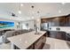 Modern kitchen with dark cabinetry, white countertops, and large island at 1337 Sorrell Way, North Port, FL 34289