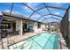 Enclosed pool area with lounge chairs and a covered patio at 1337 Sorrell Way, North Port, FL 34289