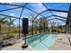 Screened-in pool with a patio and lounge chairs, offering backyard privacy at 1337 Sorrell Way, North Port, FL 34289