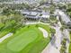 Aerial view of a clubhouse and golf course at 1384 Backspin Dr, Englewood, FL 34223