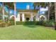 Community clubhouse with columns and lush landscaping at 1384 Backspin Dr, Englewood, FL 34223