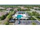 Aerial view of community pool with lounge chairs and surrounding homes at 1384 Backspin Dr, Englewood, FL 34223