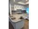 Bright kitchen with granite countertops and white cabinets at 20 Annapolis Ln, Rotonda West, FL 33947