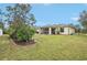 Landscaped backyard with a screened patio and solar panels on the house at 2236 Gascom St, North Port, FL 34288