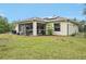 Home exterior showcasing a large backyard with screened patio and solar panels at 2236 Gascom St, North Port, FL 34288