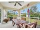 Screened porch with wooden table and seating at 2236 Gascom St, North Port, FL 34288