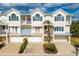Charming three-story townhome with individual garages, balconies, and manicured landscaping at 10300 Coral Landings Ct # 93, Placida, FL 33946