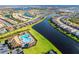 Aerial view showing community with lake, pool and numerous houses at 13092 Rinella St, Venice, FL 34293