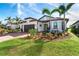 Stunning curb appeal with lush landscaping and a welcoming front porch at 13092 Rinella St, Venice, FL 34293