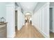 Inviting hallway featuring tile floors, decorative wood paneled walls and architectural archway at 13092 Rinella St, Venice, FL 34293