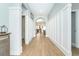 Bright hallway with wood-look tile floors and archway at 13092 Rinella St, Venice, FL 34293