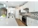 Modern kitchen with stainless steel appliances and white cabinets at 13092 Rinella St, Venice, FL 34293