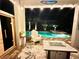 Night view of a pool and spa with a fire pit and sauna at 13092 Rinella St, Venice, FL 34293