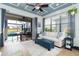 Cozy sunroom with pool access, comfortable seating, and a decorative coffered ceiling at 13092 Rinella St, Venice, FL 34293