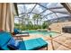 Screened pool and spa with lounge chairs at 13104 Creekside Ln, Port Charlotte, FL 33953