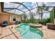 Lush backyard oasis with a screened pool and spa at 13104 Creekside Ln, Port Charlotte, FL 33953