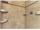 Shower with tile surround and built-in shelving at 13104 Creekside Ln, Port Charlotte, FL 33953