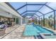 Inviting pool and spa with screened enclosure and patio area at 15764 Autry Cir, Port Charlotte, FL 33981