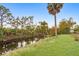 Serene canal view, lush greenery, and palm trees at 10075 Stonecrop Ave, Englewood, FL 34224