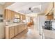 Kitchen with light wood cabinets, a white refrigerator, and tile floor at 10075 Stonecrop Ave, Englewood, FL 34224