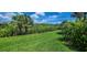 Lush green backyard with waterfront view at 15048 Spanish Point Dr, Port Charlotte, FL 33981