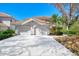 Two-car garage with driveway and manicured landscaping at 3113 Club Dr # 118, Port Charlotte, FL 33953
