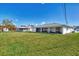 Large backyard with grassy area and screened patio at 7381 Thomas St, Englewood, FL 34224