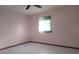Simple bedroom with window and light-colored walls at 7381 Thomas St, Englewood, FL 34224