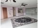 Spacious living room featuring a large area rug and ceiling fans at 7381 Thomas St, Englewood, FL 34224