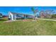 Single story home with palm tree and green lawn at 105 Crestview Dr, Englewood, FL 34223