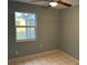 Bedroom with tile floors and a window at 21242 Glendale Ave, Port Charlotte, FL 33952