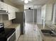 Kitchen with white cabinets, stainless steel appliances, and tile floors at 21242 Glendale Ave, Port Charlotte, FL 33952