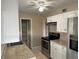 Kitchen boasts white cabinets and stainless steel appliances at 21242 Glendale Ave, Port Charlotte, FL 33952