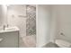 Stylish bathroom with double vanity, patterned tile shower, and toilet at 384 Baytree Dr, Rotonda West, FL 33947