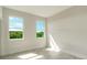 Bright bedroom featuring two windows and tile floors at 384 Baytree Dr, Rotonda West, FL 33947