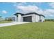 Gray house with dark gray roof and paver driveway at 384 Baytree Dr, Rotonda West, FL 33947