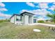 Single-story home with gray exterior and landscaping at 384 Baytree Dr, Rotonda West, FL 33947